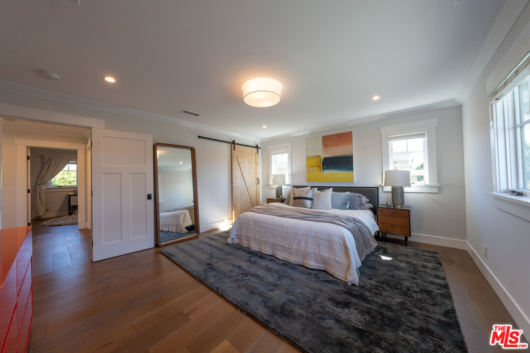 385 North Wilton Place Los Angeles, CA 90004 - Photo 33 of 53 a spacious bedroom with a bed and wooden floor