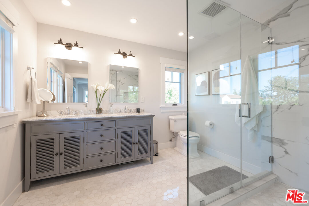 385 North Wilton Place Los Angeles, CA 90004 - Photo 34 of 53 a spacious bathroom with a double vanity sink mirror and double