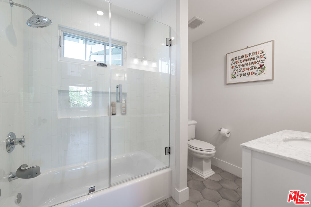 385 North Wilton Place Los Angeles, CA 90004 - Photo 40 of 53 a bathroom with a shower a toilet and sink
