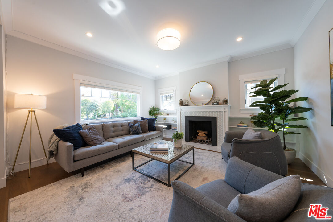 385 North Wilton Place Los Angeles, CA 90004 - Photo 5 of 53 a living room with furniture a potted plant and a fireplace