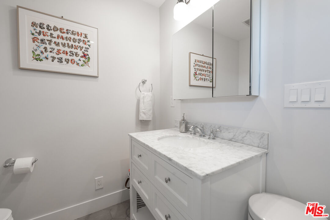 385 North Wilton Place Los Angeles, CA 90004 - Photo 41 of 53 a bathroom with a sink and a toilet
