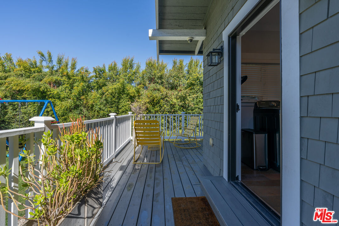 385 North Wilton Place Los Angeles, CA 90004 - Photo 43 of 53 a view of a balcony with wooden floor and bench in wooden floor