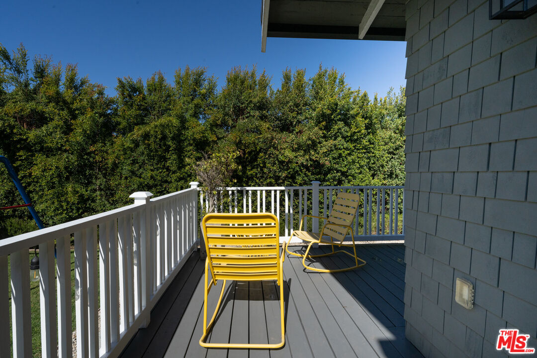 385 North Wilton Place Los Angeles, CA 90004 - Photo 44 of 53 a view of balcony with wooden floor and fence