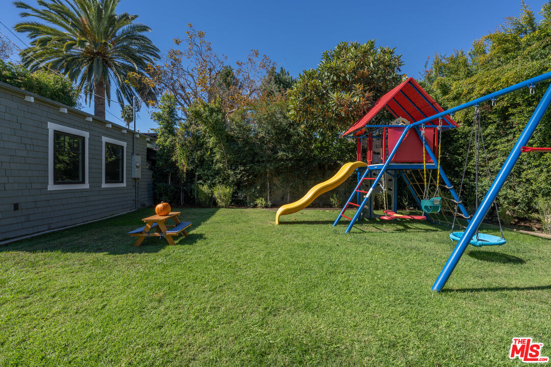 385 North Wilton Place Los Angeles, CA 90004 - Photo 46 of 53 a view of a backyard with a slide and a wooden bench