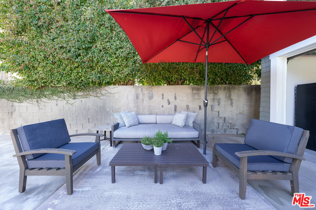 385 North Wilton Place Los Angeles, CA 90004 - Photo 49 of 53 a outdoor living space with furniture and a umbrella