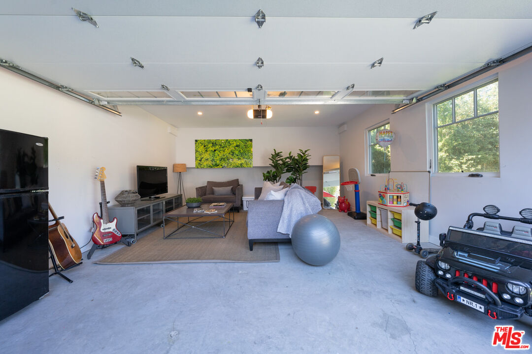 385 North Wilton Place Los Angeles, CA 90004 - Photo 50 of 53 a living room with furniture a flat screen tv and a large window