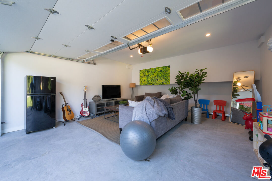 385 North Wilton Place Los Angeles, CA 90004 - Photo 51 of 53 a living room with furniture and a flat screen tv