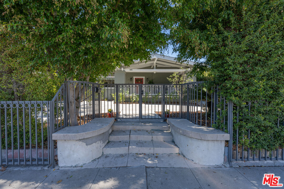 385 North Wilton Place Los Angeles, CA 90004 - Photo 52 of 53 a view of a house with a small yard and wooden fence