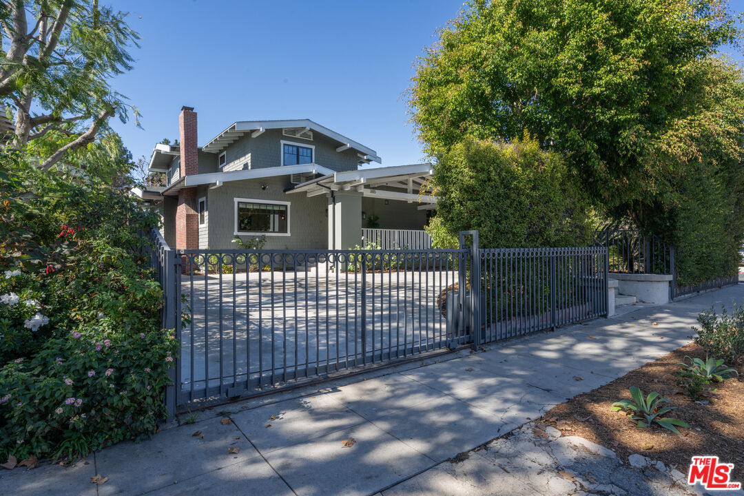 385 North Wilton Place Los Angeles, CA 90004 - Photo 53 of 53 a view of a brick house with large windows and a small yard