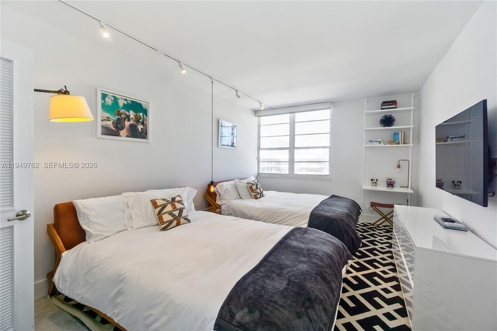 100 Lincoln Road, Unit 1447 Miami Beach, FL 33139 - Photo 12 of 39 a bedroom with a bed and a flat screen tv