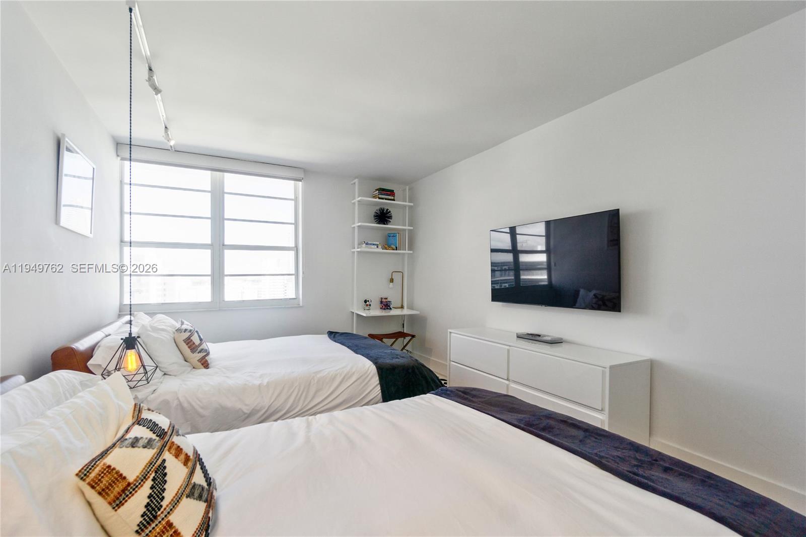 100 Lincoln Road, Unit 1447 Miami Beach, FL 33139 - Photo 13 of 39 a bedroom with two beds and a flat screen tv