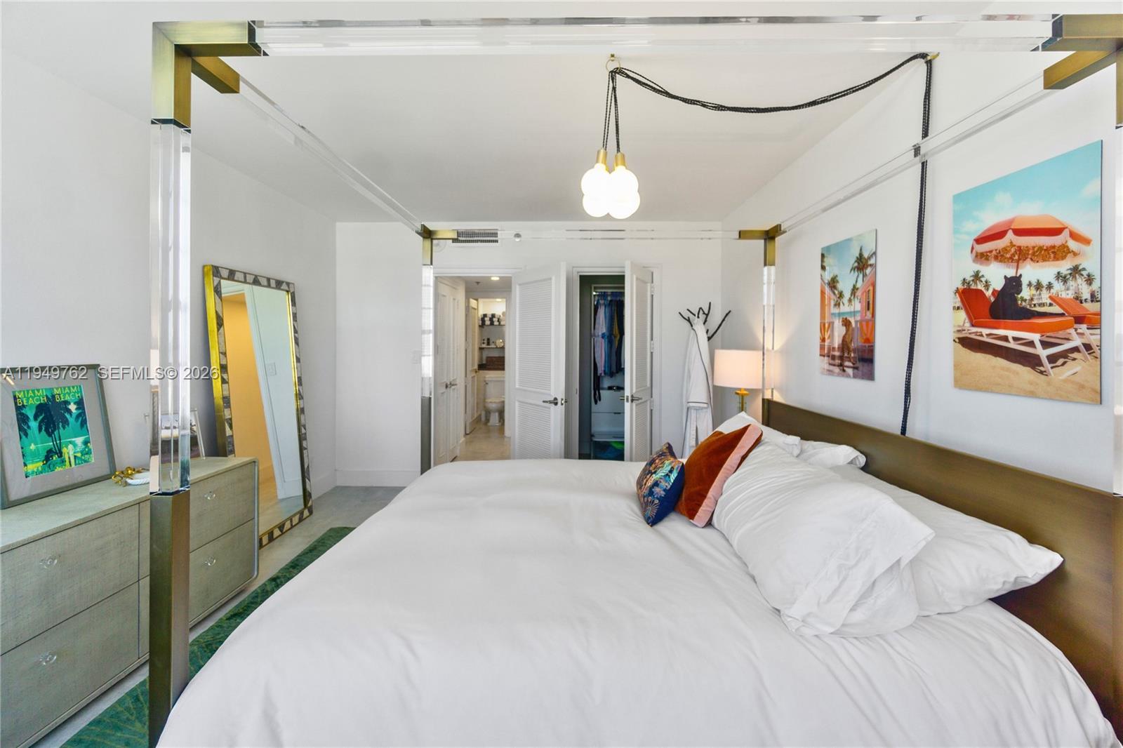 100 Lincoln Road, Unit 1447 Miami Beach, FL 33139 - Photo 20 of 39 a bedroom with a large bed and a chandelier