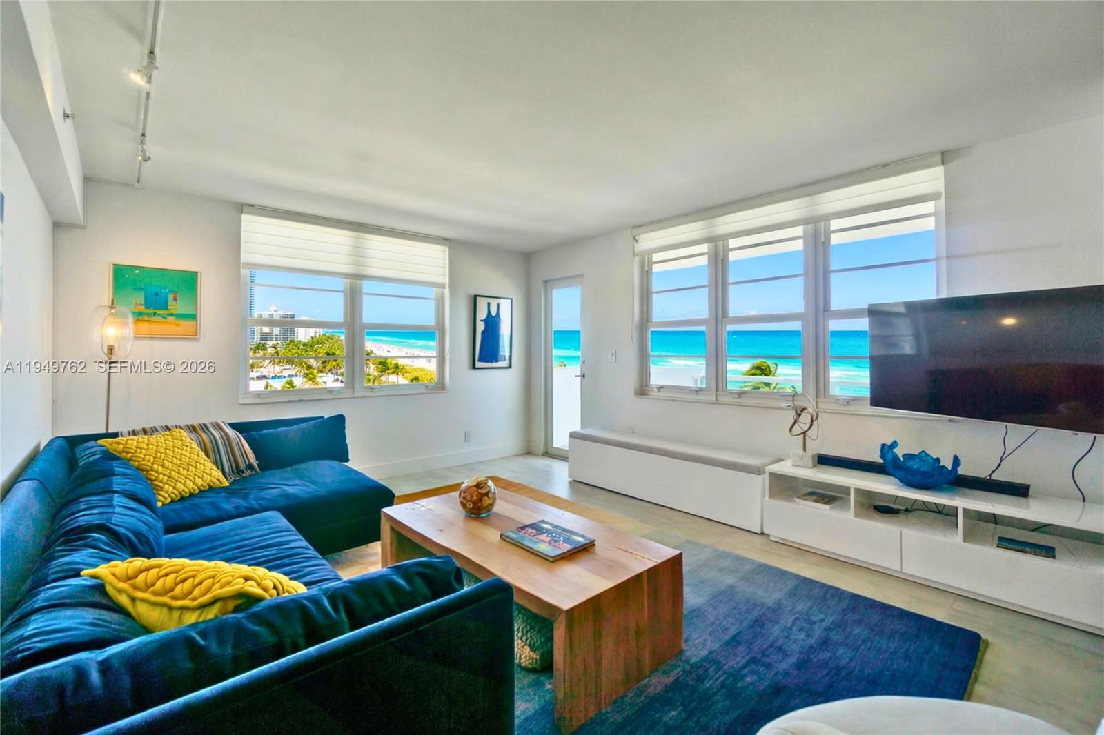 100 Lincoln Road, Unit 1447 Miami Beach, FL 33139 - Photo 3 of 39 a living room with furniture and a flat screen tv