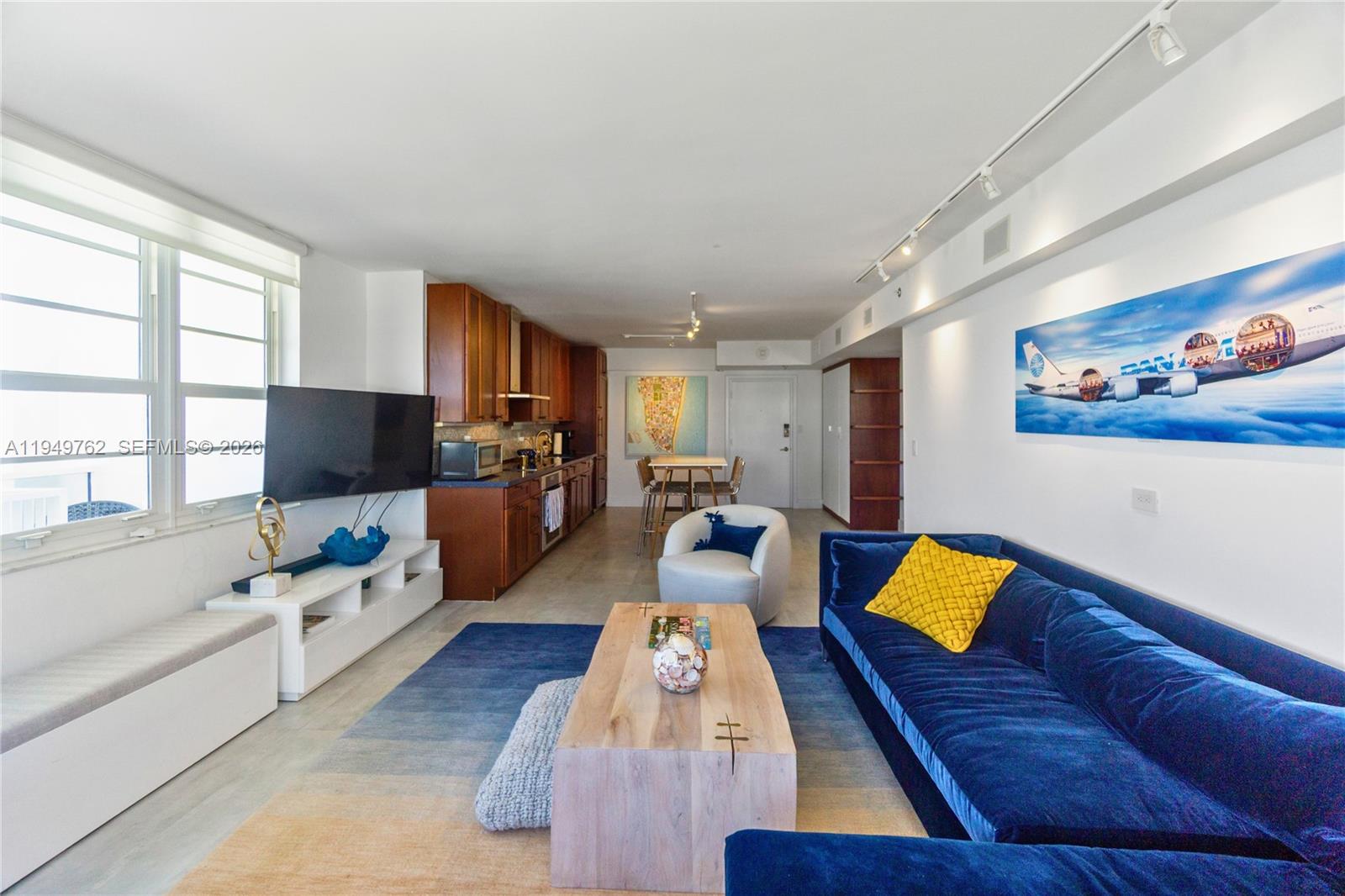 100 Lincoln Road, Unit 1447 Miami Beach, FL 33139 - Photo 5 of 39 a living room with furniture and a flat screen tv
