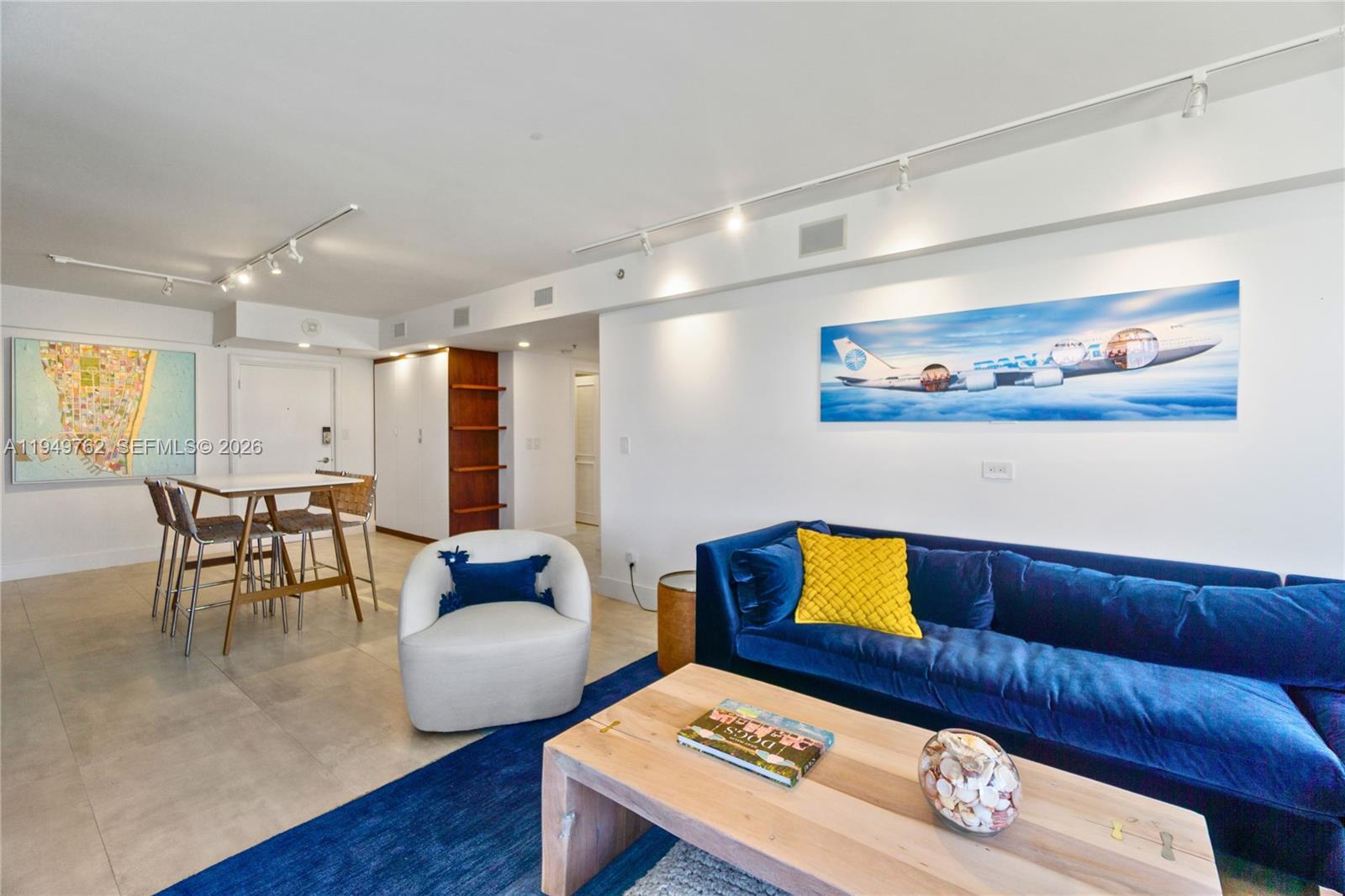 100 Lincoln Road, Unit 1447 Miami Beach, FL 33139 - Photo 6 of 39 a living room with furniture and wooden floor