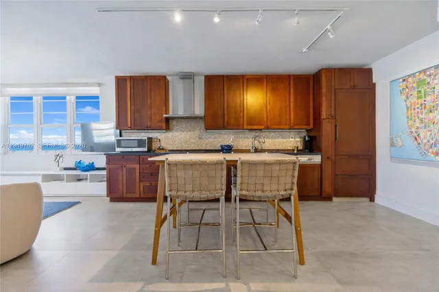 a kitchen with a table chairs sink and cabinets