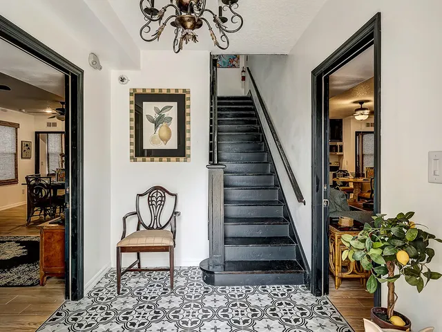a living room with furniture and kitchen view
