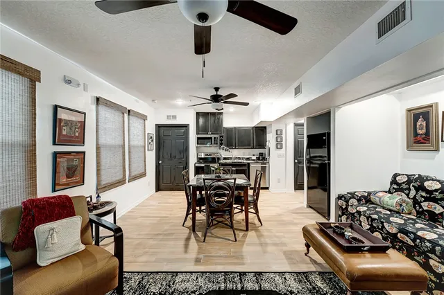a kitchen with stainless steel appliances kitchen island a refrigerator and a stove top oven