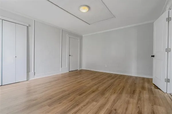 a view of an empty room and wooden floor