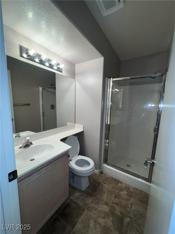 8028 Desire Drive Las Vegas, NV 89128 - Photo 14 of 15 Full bathroom featuring a shower stall, vanity, and a textured ceiling