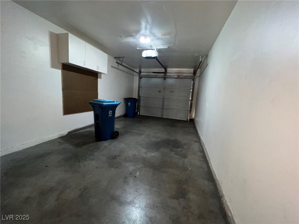 8028 Desire Drive Las Vegas, NV 89128 - Photo 9 of 15 Garage with baseboards and a garage door opener