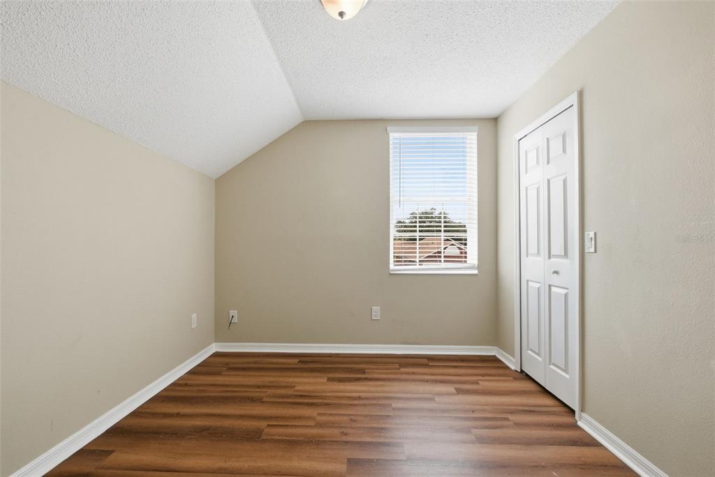 617 Greys Ferry Road Orlando, FL 32811 - Photo 18 of 35 a view of an empty room with wooden floor and a window