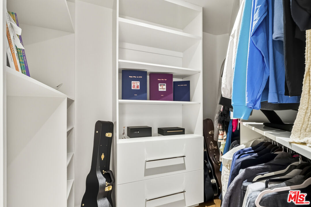 3140 Sweetwater Mesa Road Malibu, CA 90265 - Photo 32 of 71 a view of walk in closet with clothes and shoes