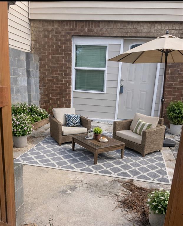 a outdoor space with patio couch and a potted plant