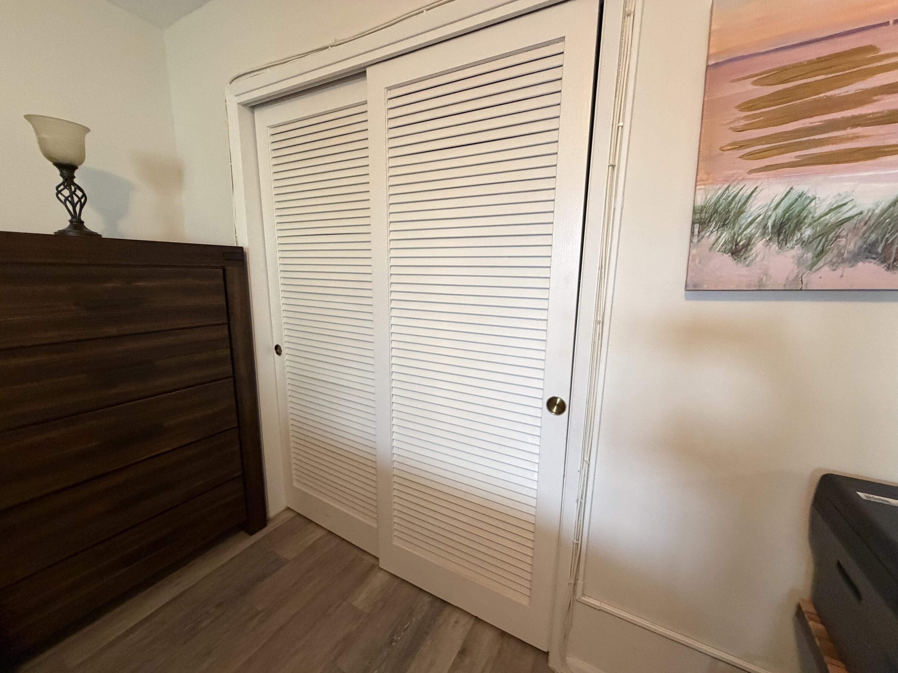 2050 Northeast 39th Street, Unit S103 Lighthouse Point, FL 33064 - Photo 14 of 46 a view of a hallway with entryway wooden floor and front door