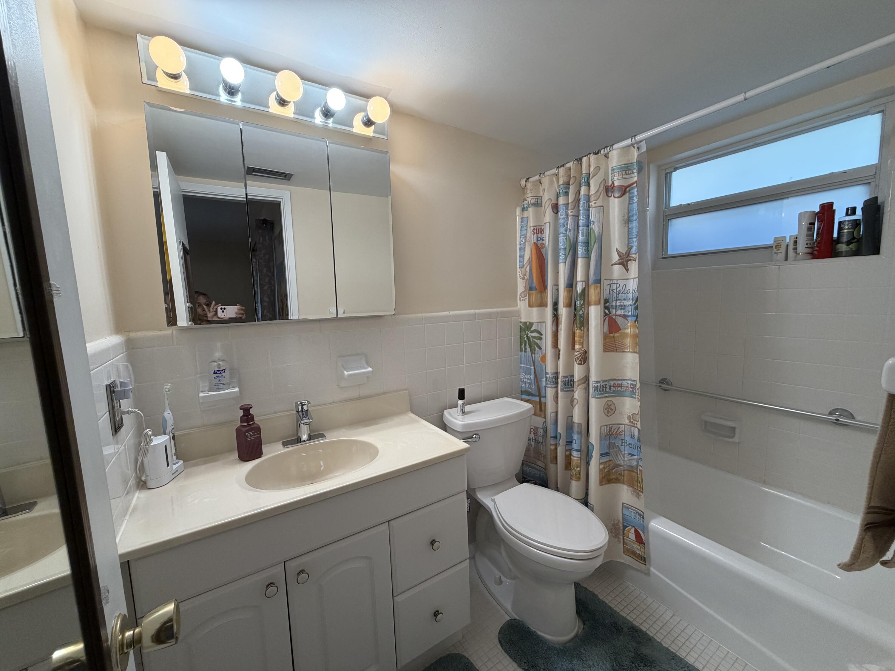 2050 Northeast 39th Street, Unit S103 Lighthouse Point, FL 33064 - Photo 20 of 46 a bathroom with a sink a toilet and shower
