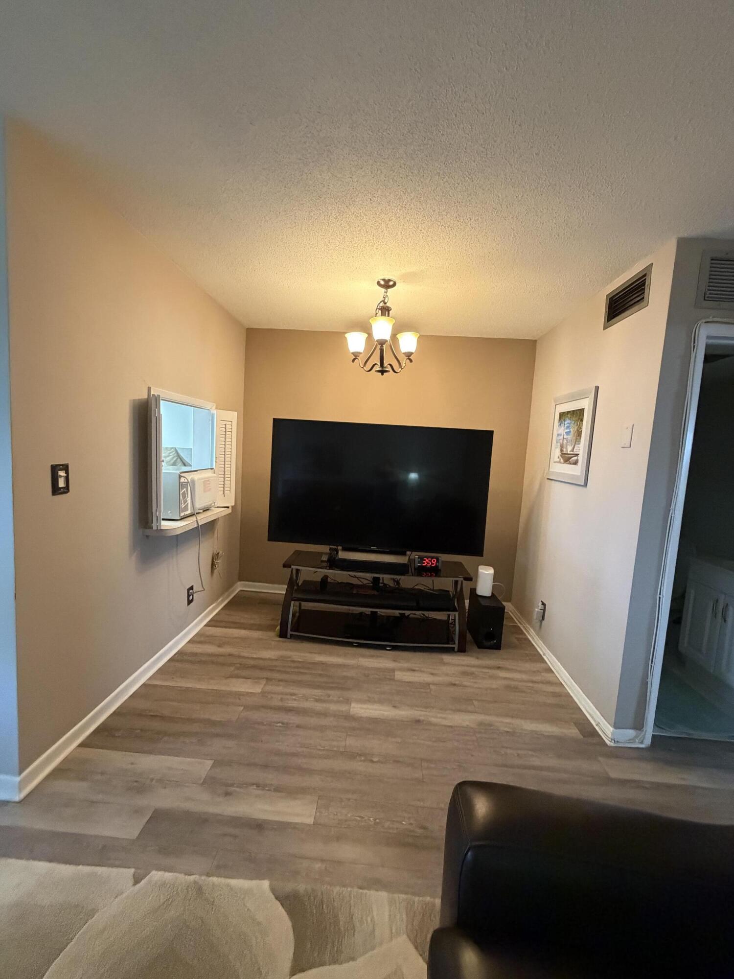 2050 Northeast 39th Street, Unit S103 Lighthouse Point, FL 33064 - Photo 32 of 46 a living room with furniture and a flat screen tv