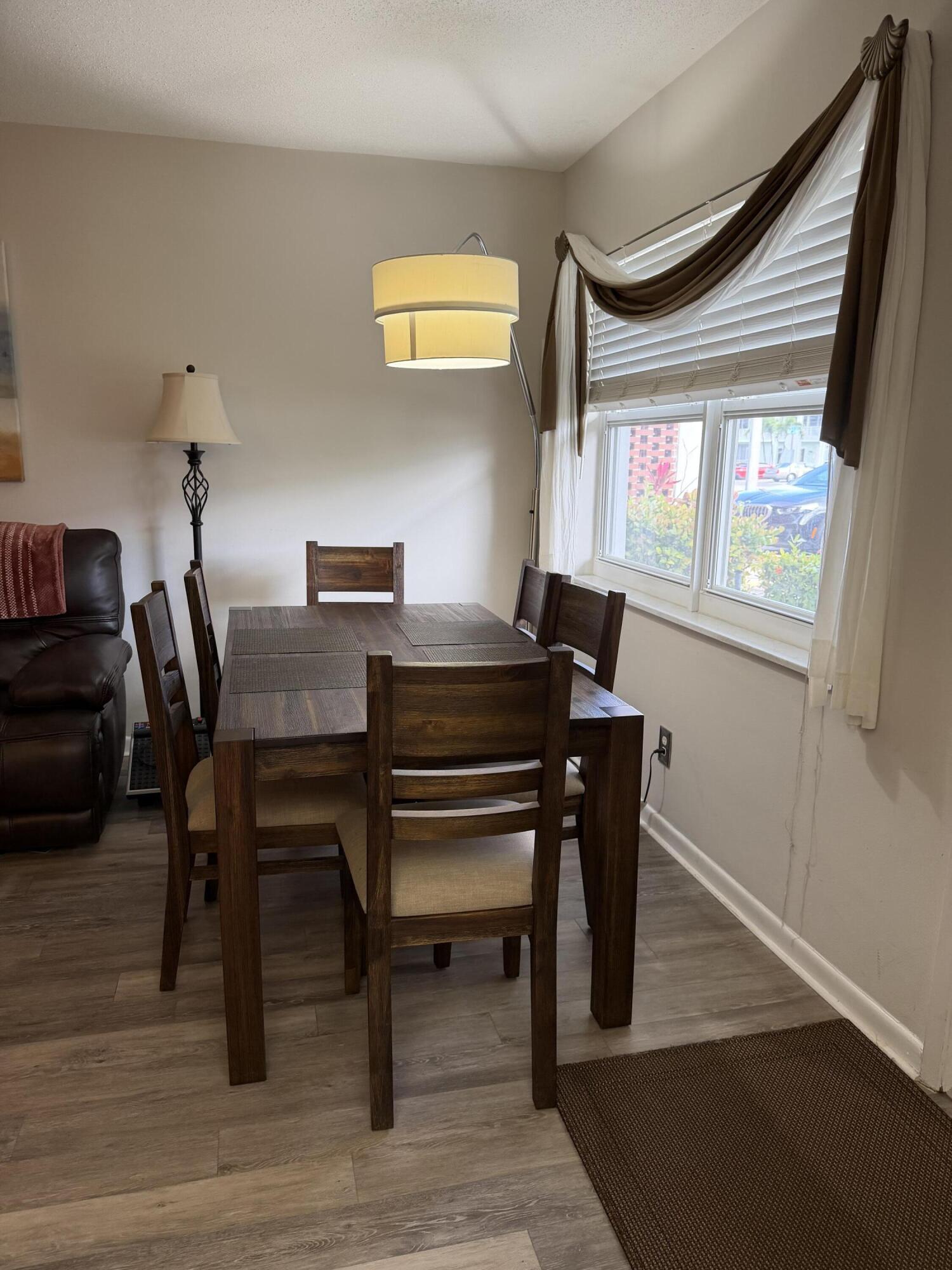 2050 Northeast 39th Street, Unit S103 Lighthouse Point, FL 33064 - Photo 38 of 46 a view of a dining room with furniture and a window