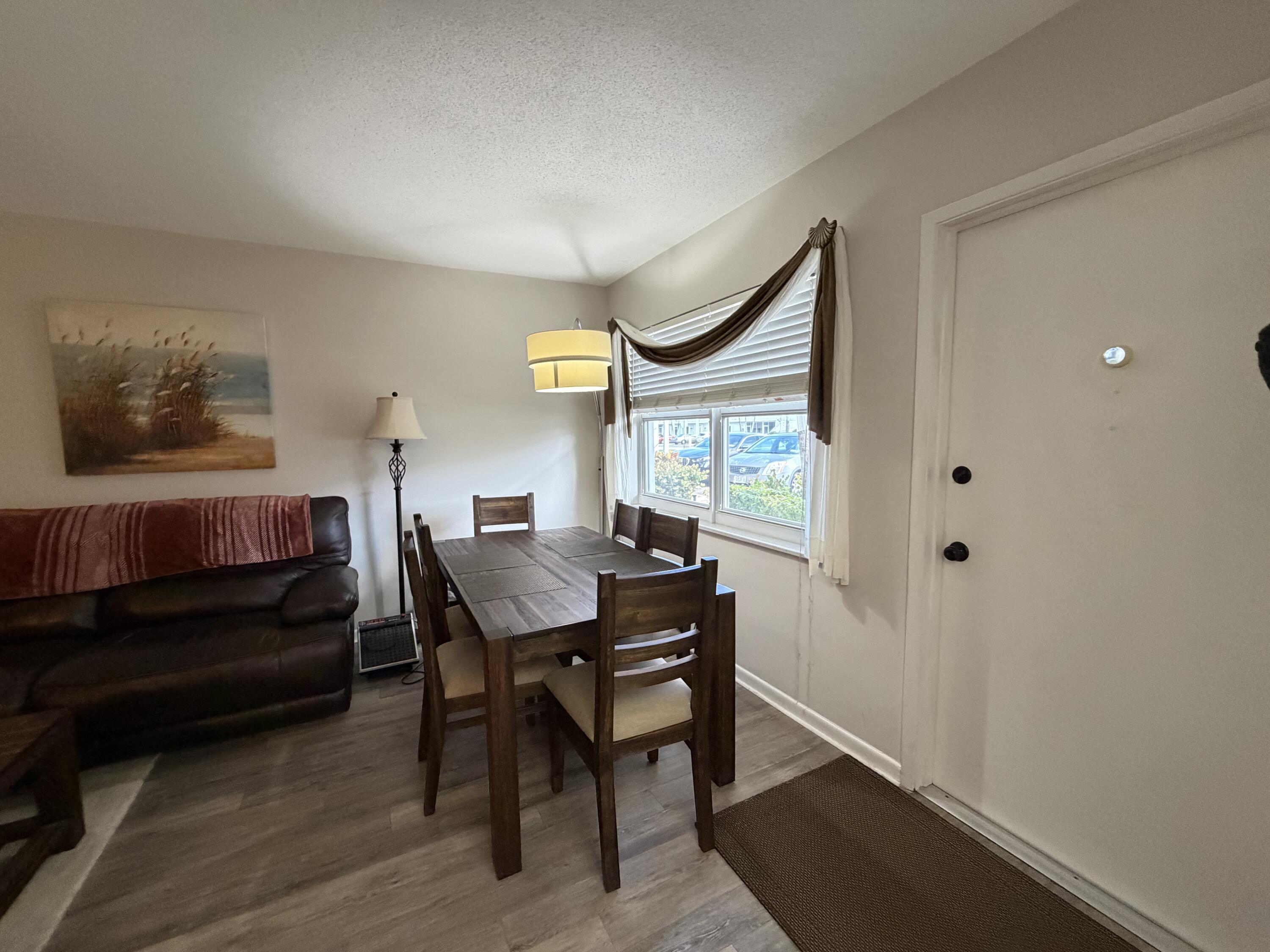 2050 Northeast 39th Street, Unit S103 Lighthouse Point, FL 33064 - Photo 39 of 46 a view of a livingroom with furniture and window