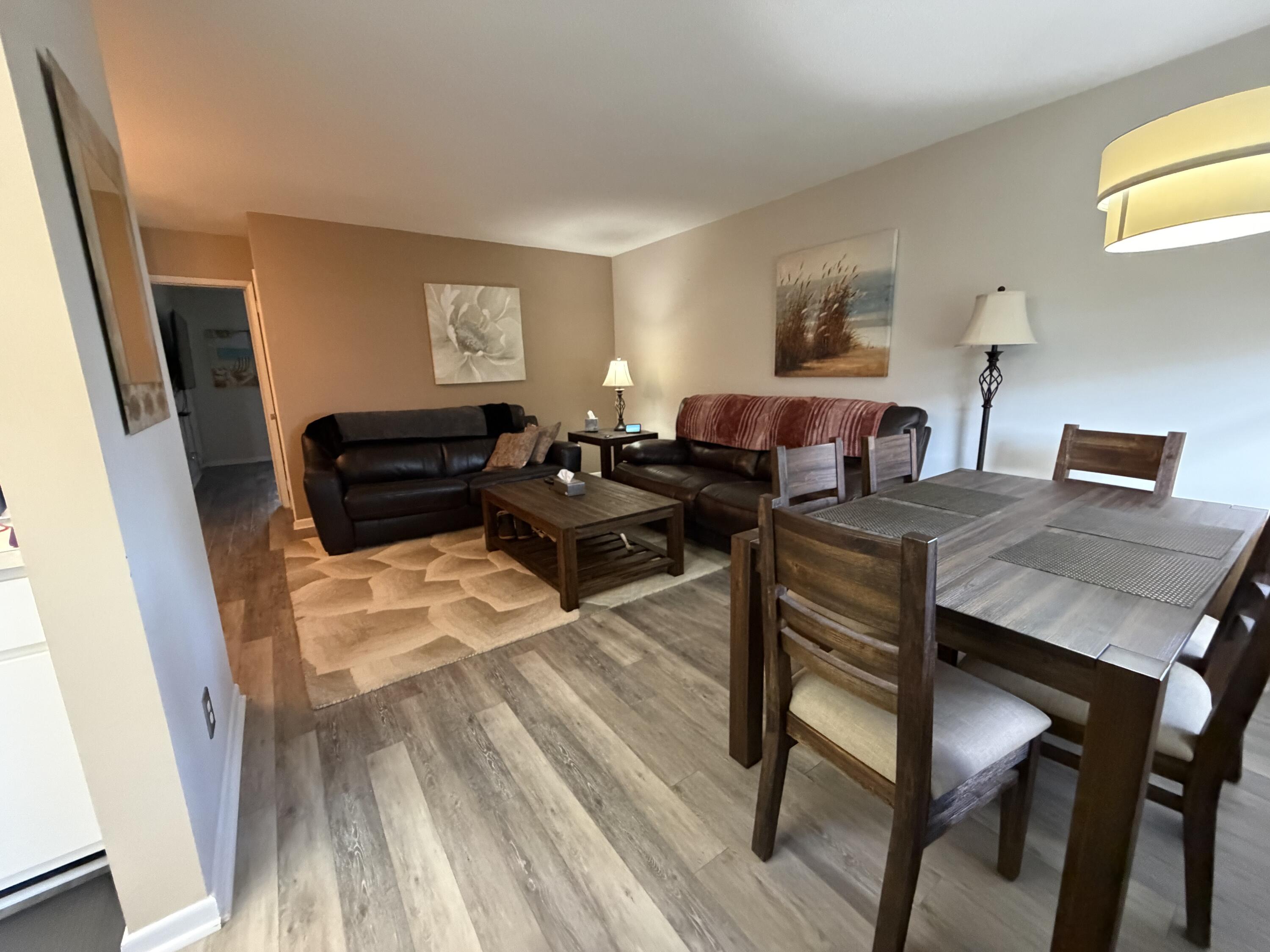 2050 Northeast 39th Street, Unit S103 Lighthouse Point, FL 33064 - Photo 41 of 46 a living room with furniture and wooden floor