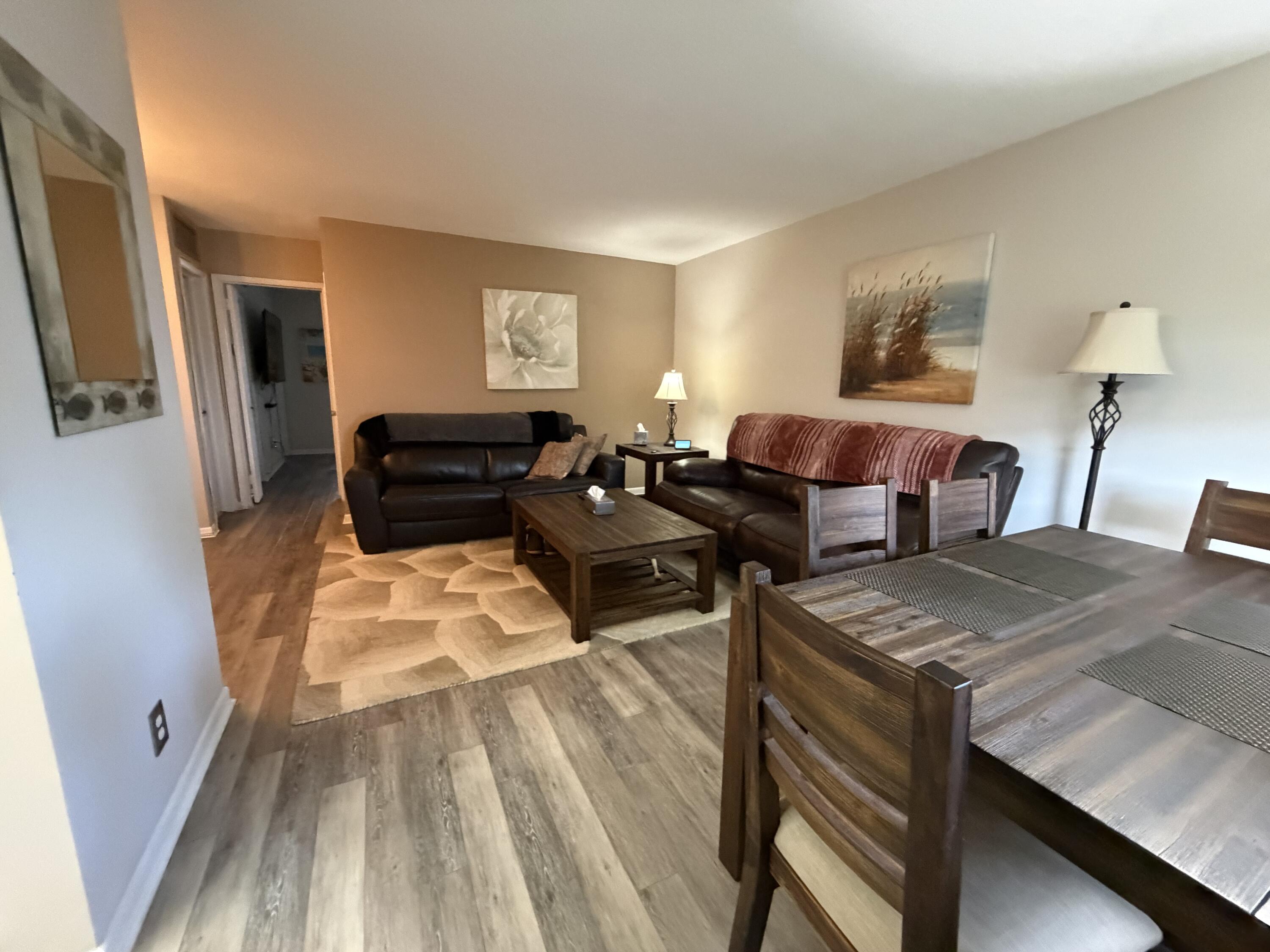 2050 Northeast 39th Street, Unit S103 Lighthouse Point, FL 33064 - Photo 5 of 46 a living room with furniture and a flat screen tv