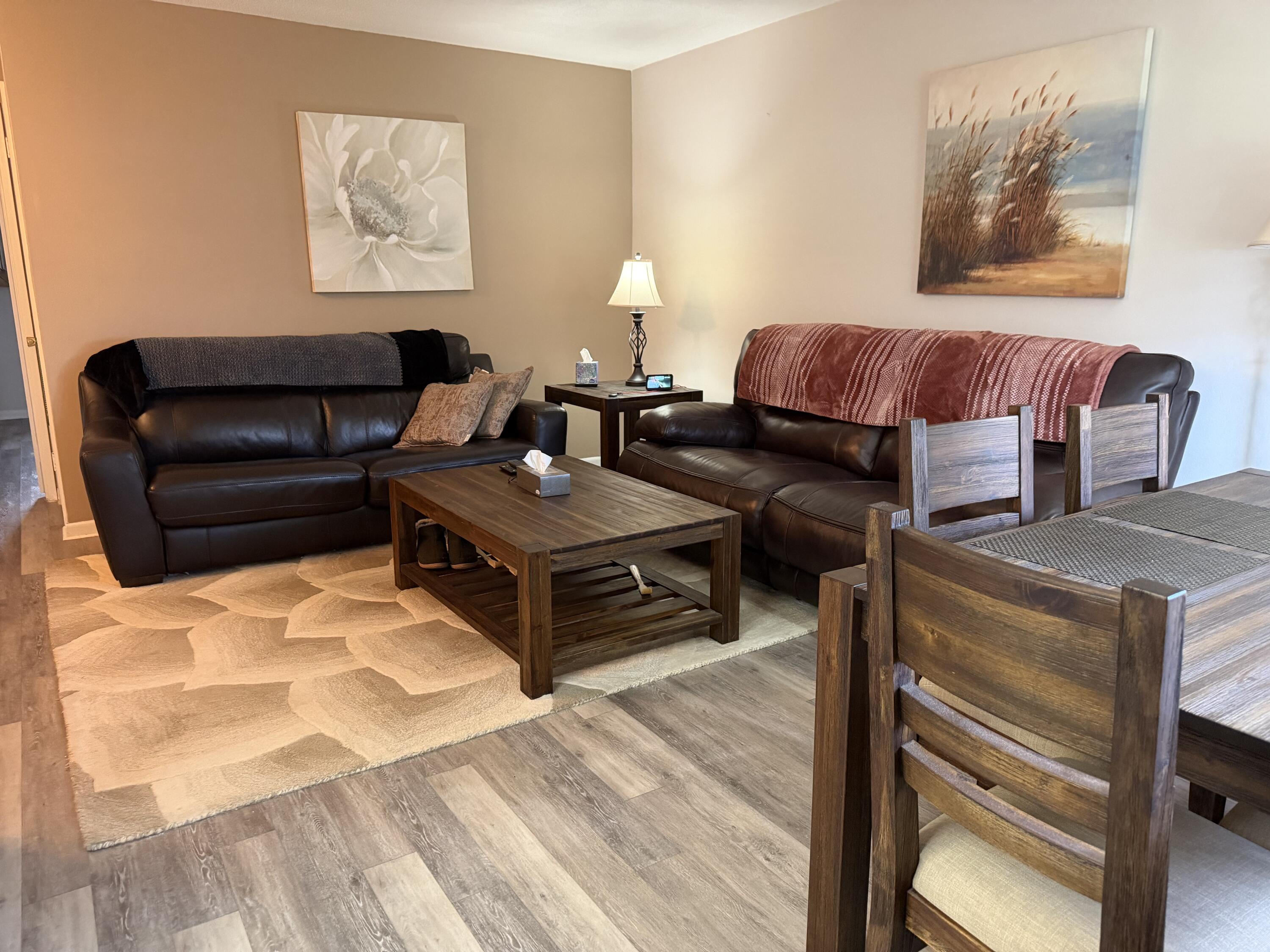 2050 Northeast 39th Street, Unit S103 Lighthouse Point, FL 33064 - Photo 7 of 46 a living room with furniture and wooden floor