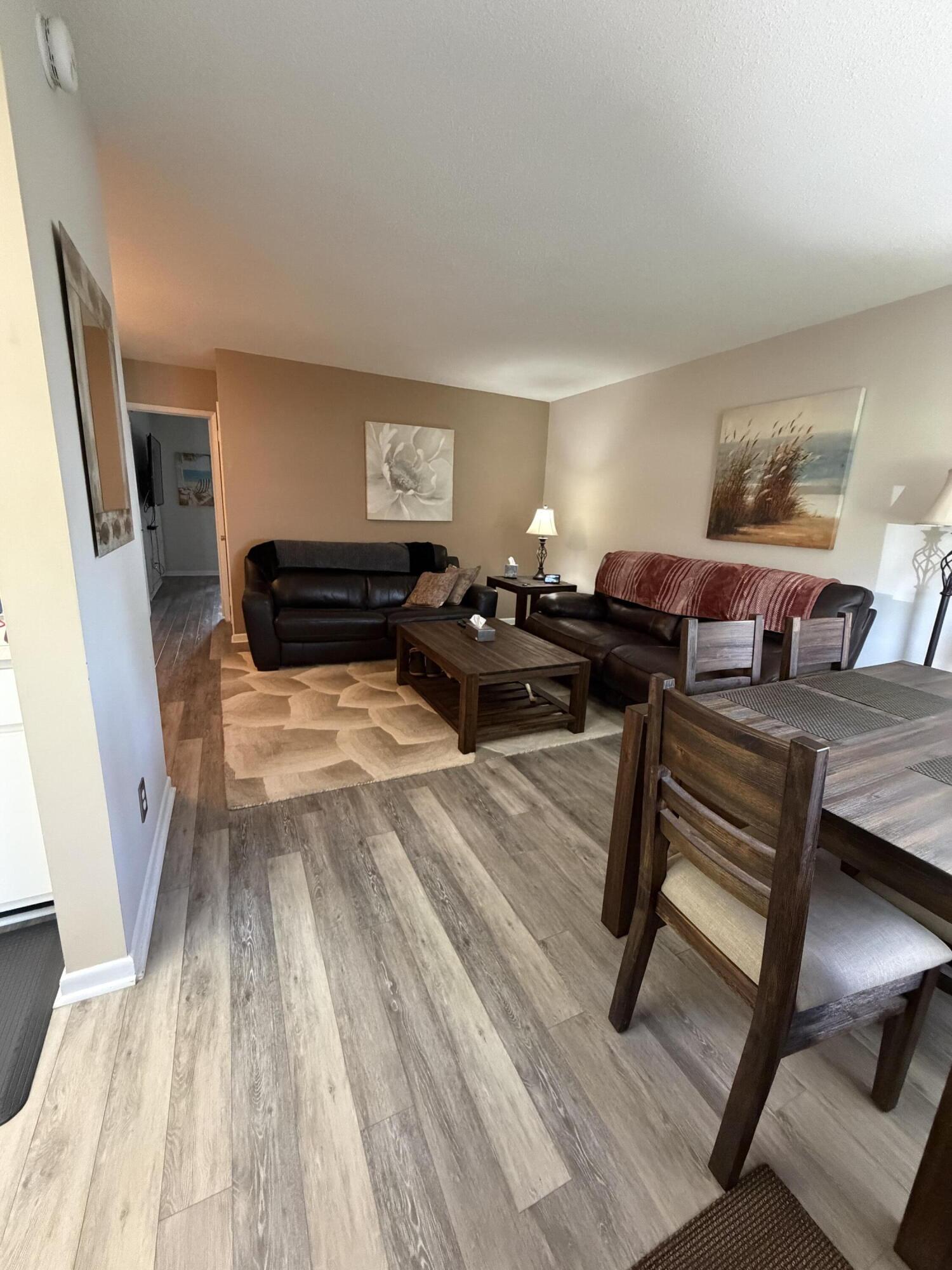 2050 Northeast 39th Street, Unit S103 Lighthouse Point, FL 33064 - Photo 8 of 46 a living room with furniture and a wooden floor