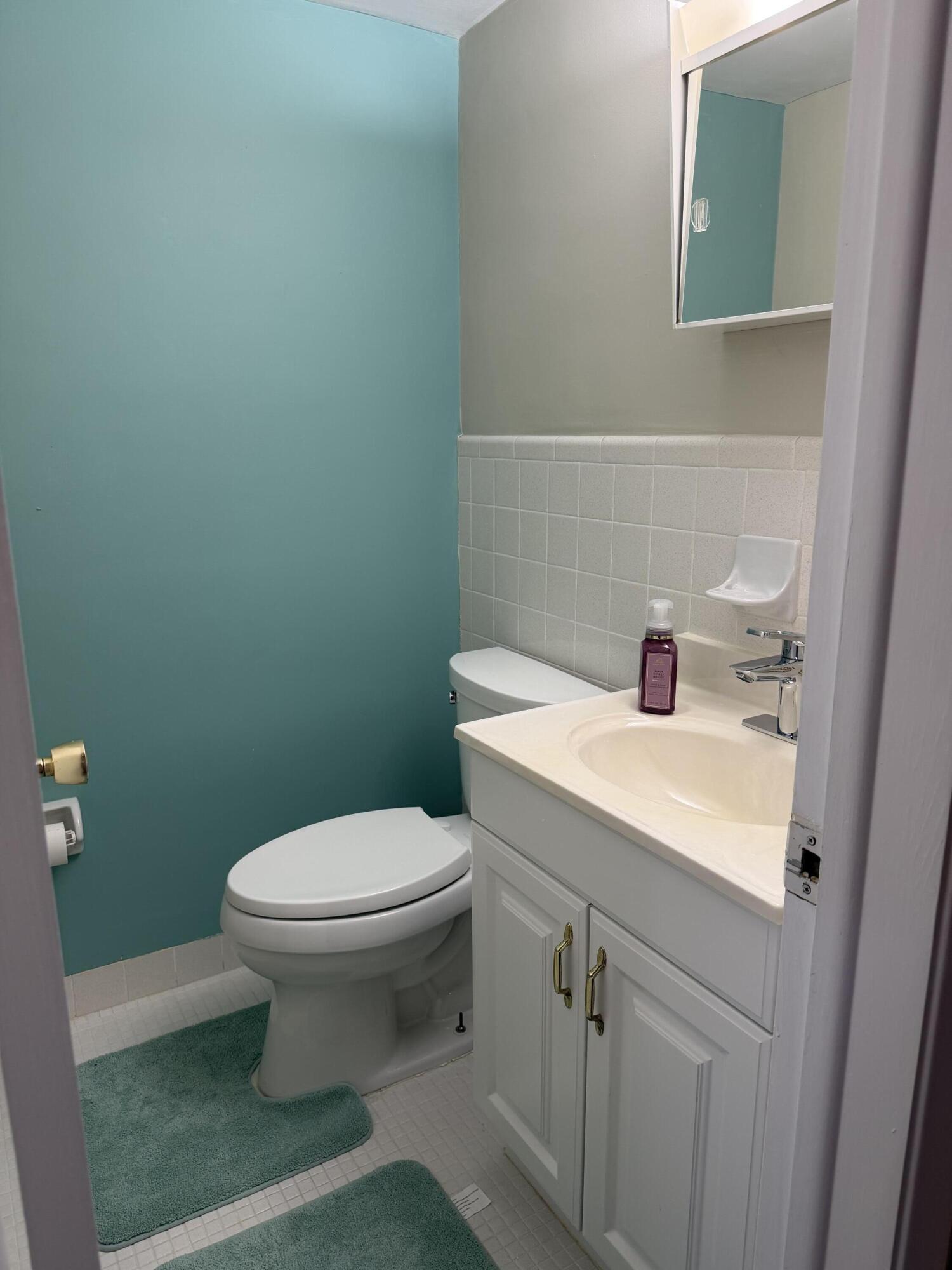 2050 Northeast 39th Street, Unit S103 Lighthouse Point, FL 33064 - Photo 10 of 46 a bathroom with a sink and a toilet