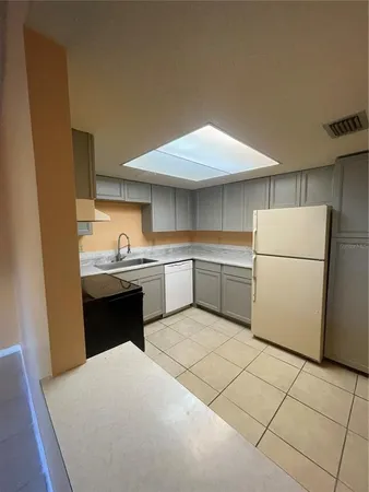 a kitchen with a sink a stove and refrigerator