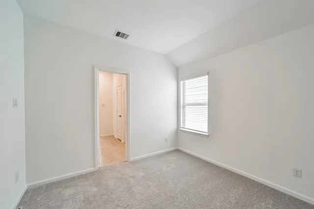 a spacious bathroom with a granite countertop sink and a mirror
