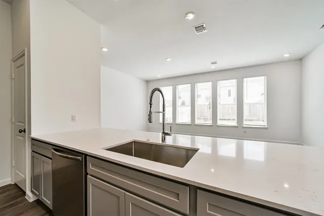 a kitchen with stainless steel appliances granite countertop a stove a sink and a microwave