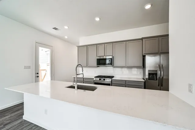 a kitchen with counter top space cabinets and stainless steel appliances