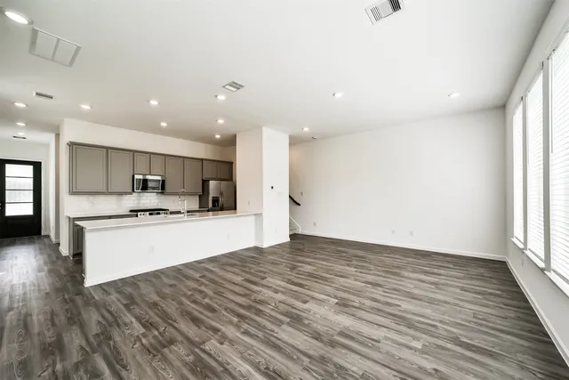 a view of a room with wooden floor