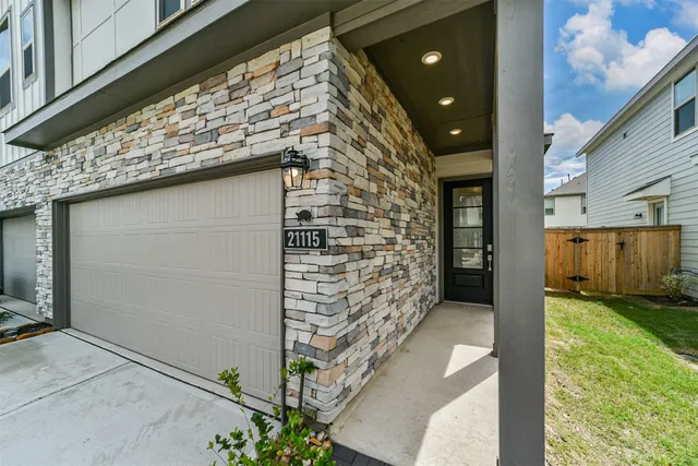 a view of a wooden door and brick walls