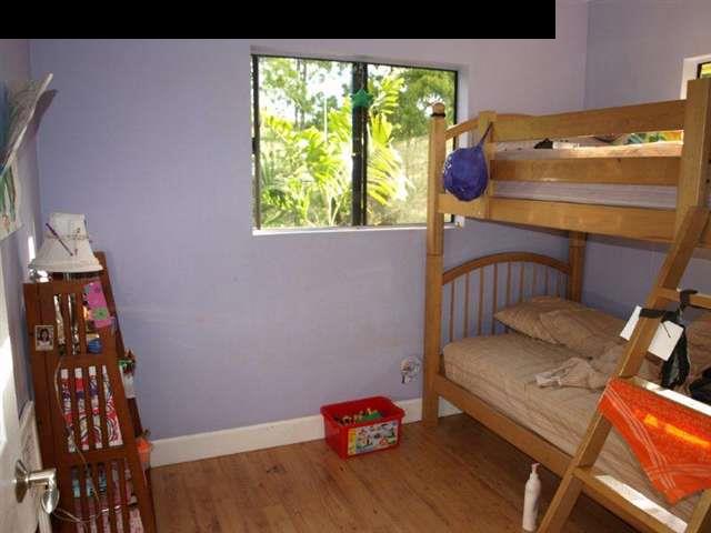 299 Awalau Road Haiku, HI 96708 - Photo 7 of 12 a bedroom with a bed and a window