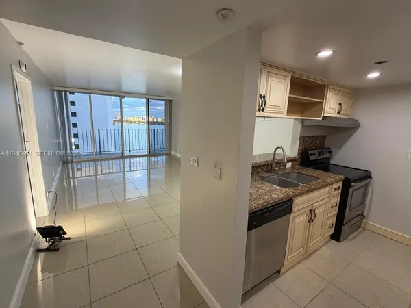a kitchen with stainless steel appliances granite countertop a stove and a refrigerator