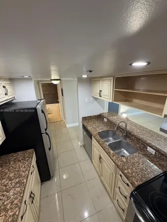 a kitchen with a stove and a sink