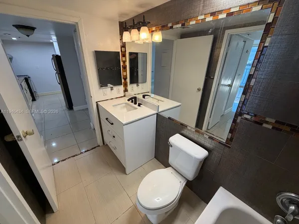 a white toilet sitting next to a bathroom sink