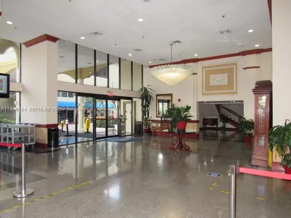 a lobby with furniture and a floor to ceiling window