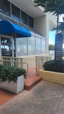a view of a kitchen with furniture and wooden floor